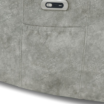 Close-up of a grey faux-leather upholstered surface with a rectangular pocket and a small control panel near the top edge.