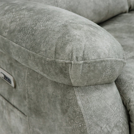 Close-up of a grey textured recliner sofa cushion and armrest, showing the fabric texture and a small control panel on the side.