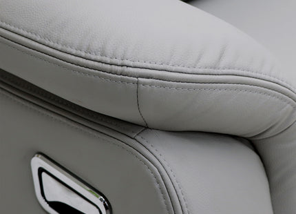 Close-up of a light grey leather recliner chair showing the armrest, stitching, and a chrome control panel.