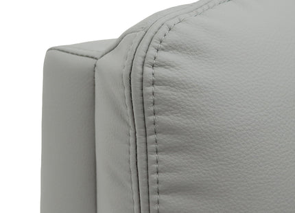 Close-up of a light grey upholstered chair or sofa corner with visible stitching and pebbled texture on a white background.