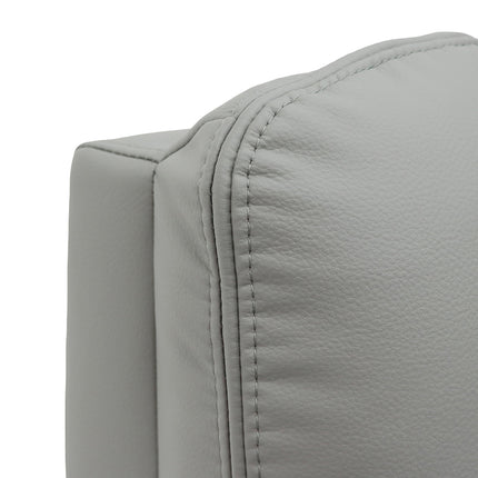 Close-up of a light grey upholstered chair or sofa corner with visible stitching and pebbled texture on a white background.