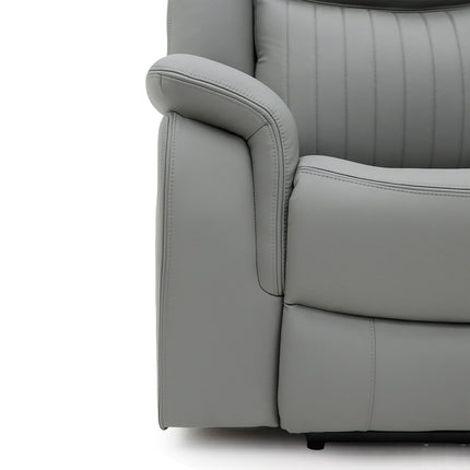 Close-up of a light grey upholstered recliner chair showing the armrest, side panel, and vertical channel stitching on a white background.